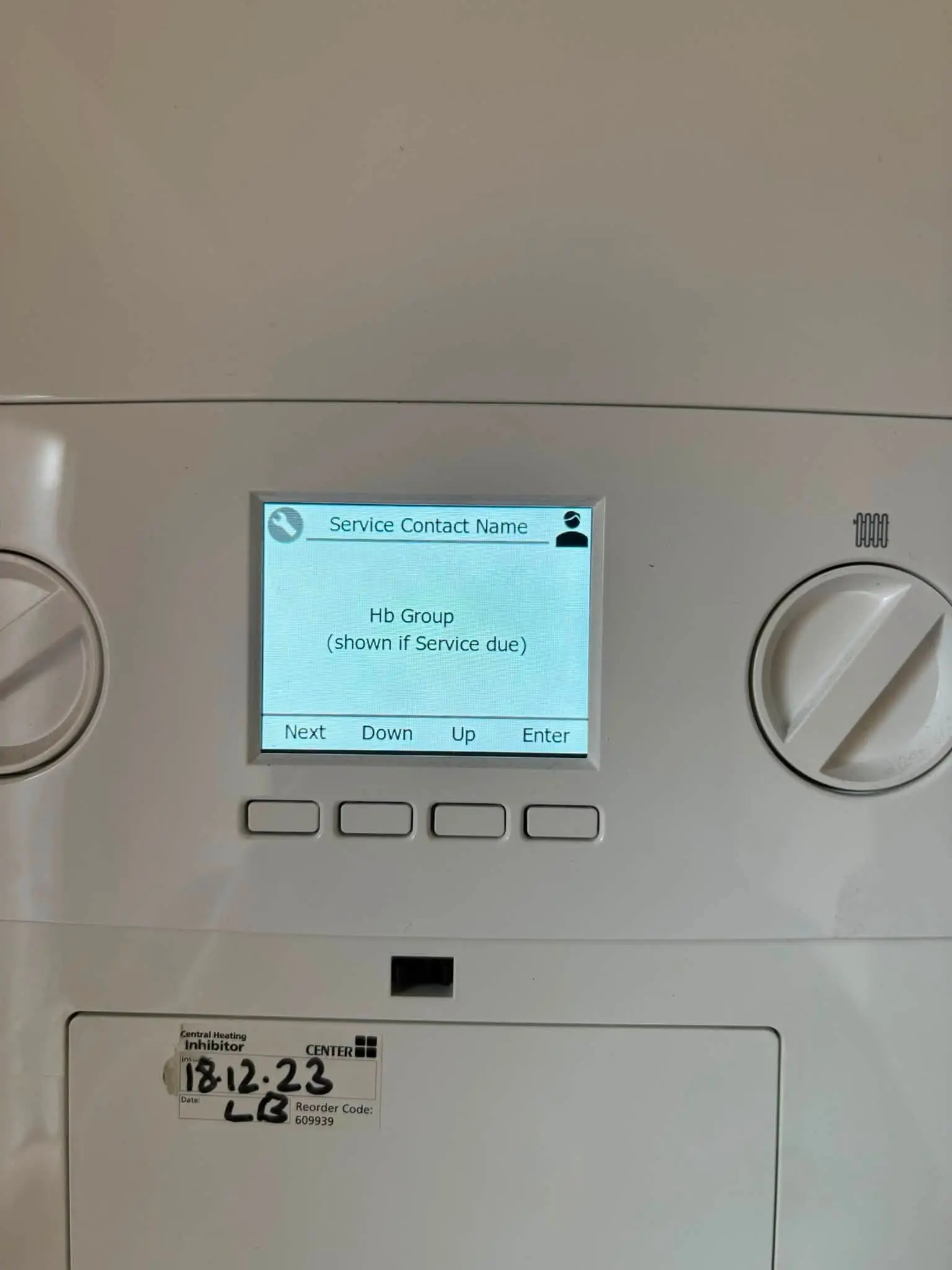 Boiler servicing display showing HB Group service contact details